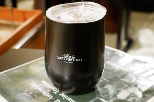 Black tumbler with 'Matcha Over Everything' text on a marble surface
