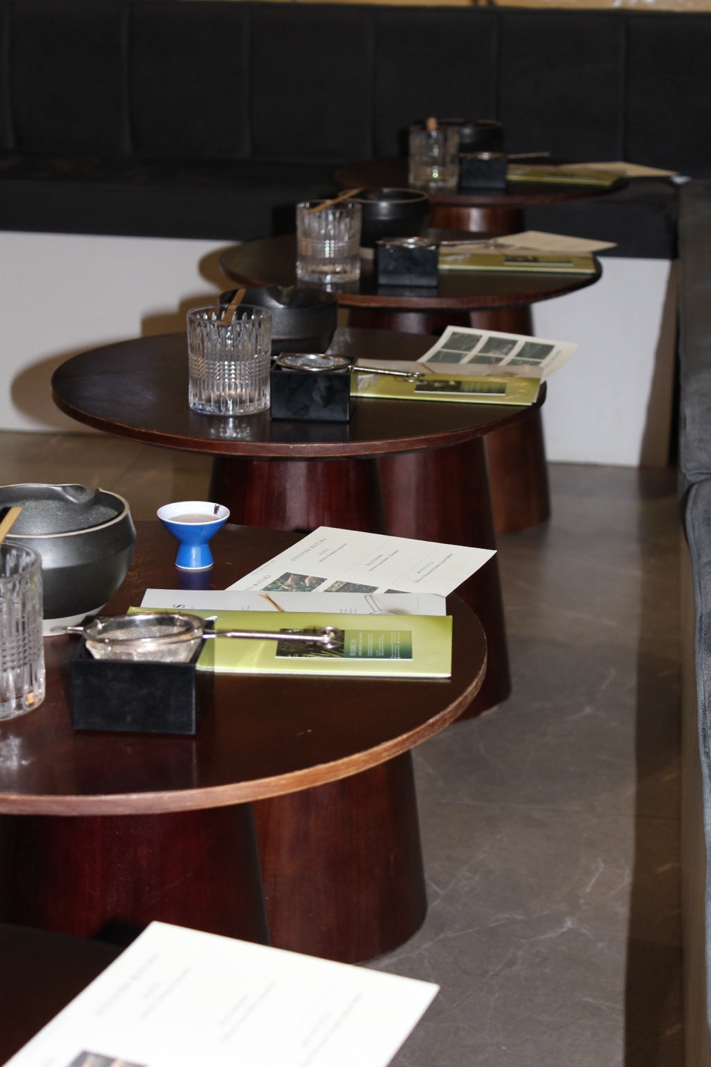 Matcha workshop tables prepared with tea bowls, sifters and tasting guides